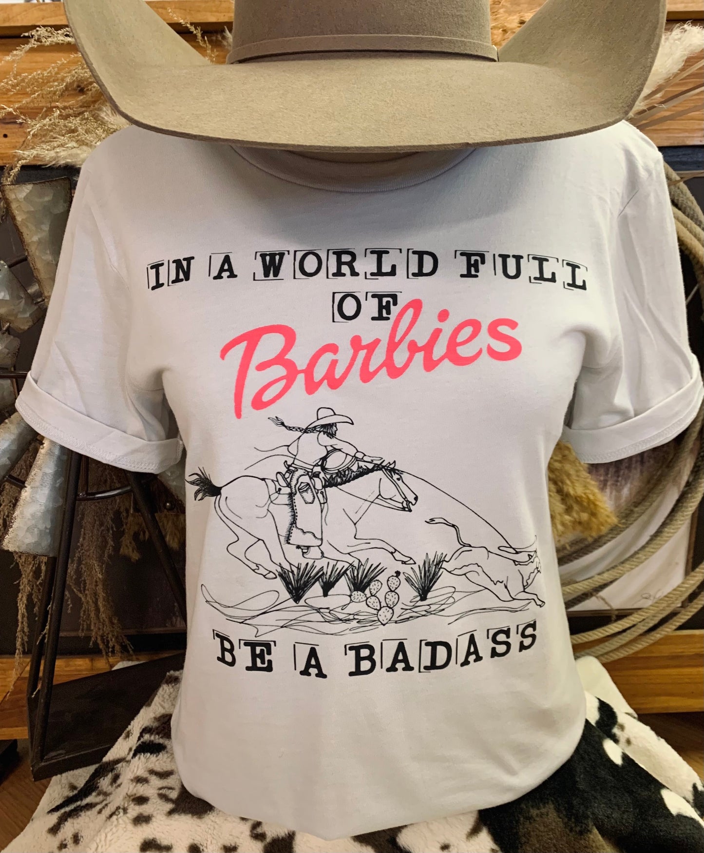 In A World Full of Barbies Be A Badass Western Graphic Tee